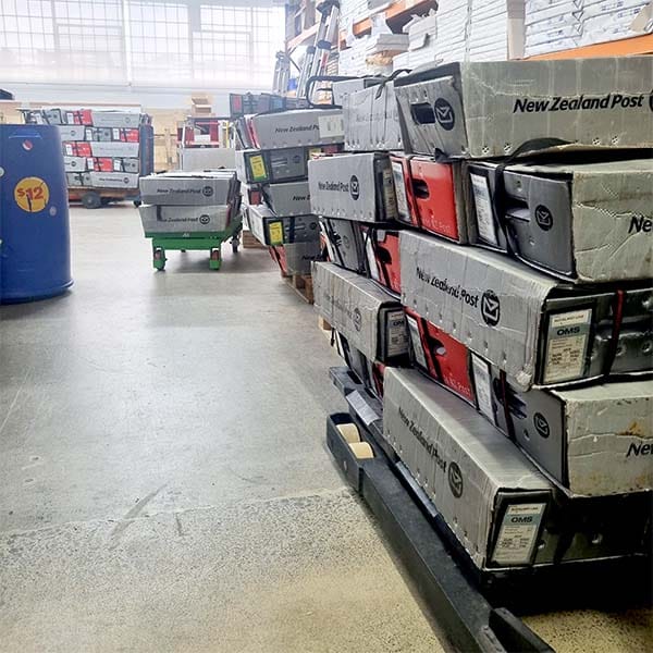 Direct Print & Mail Solutions facility with branded merchandise on shelves