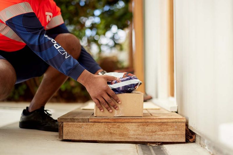NZ Post courier delivering a package to a doorstep